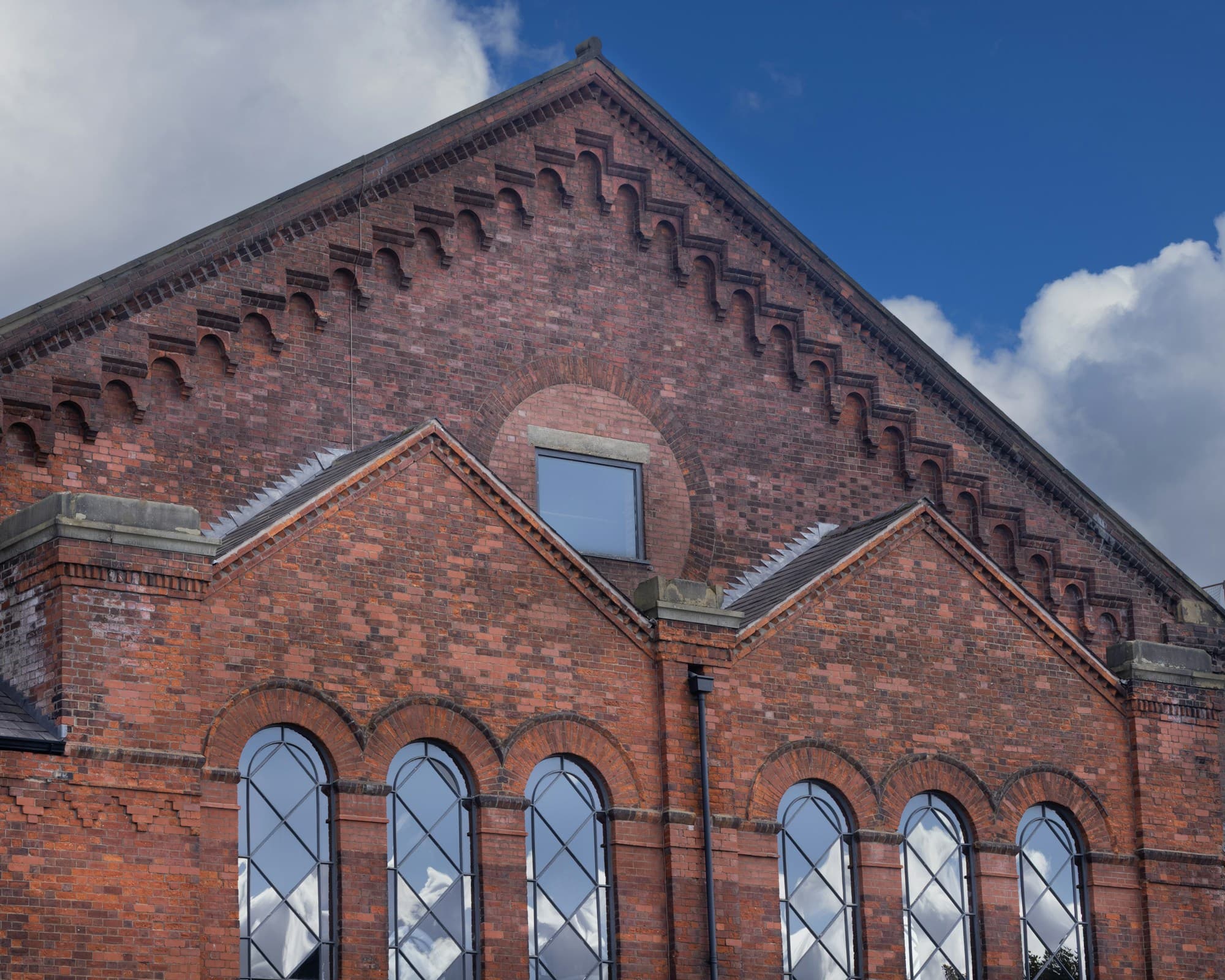 English red brick warehouse building with arched windows
